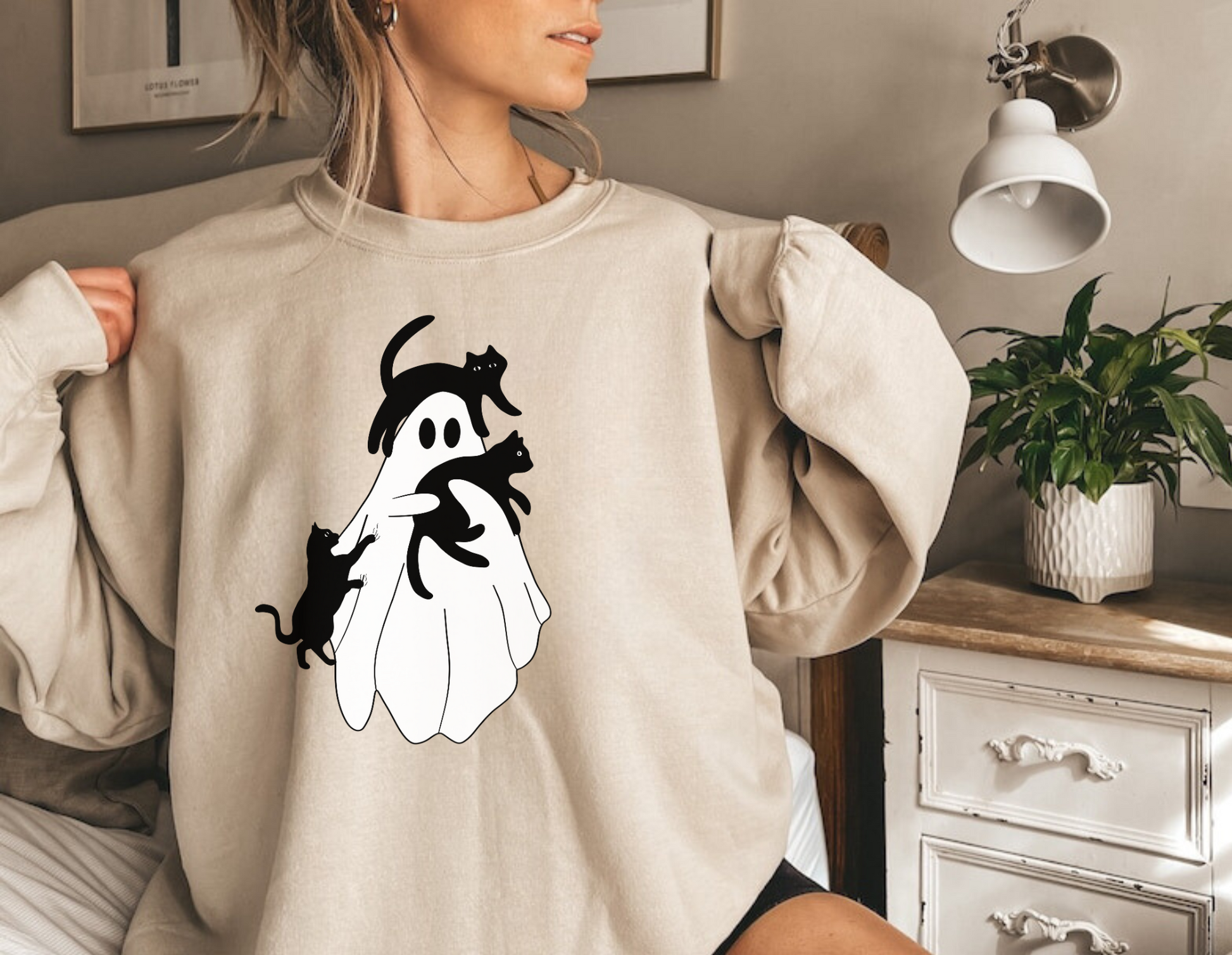 A stylish oversized sweatshirt with a cute and spooky ghost cat design, perfect for Halloween and cat lovers. The black cat ghost adds a touch of whimsy to your fall outfit.