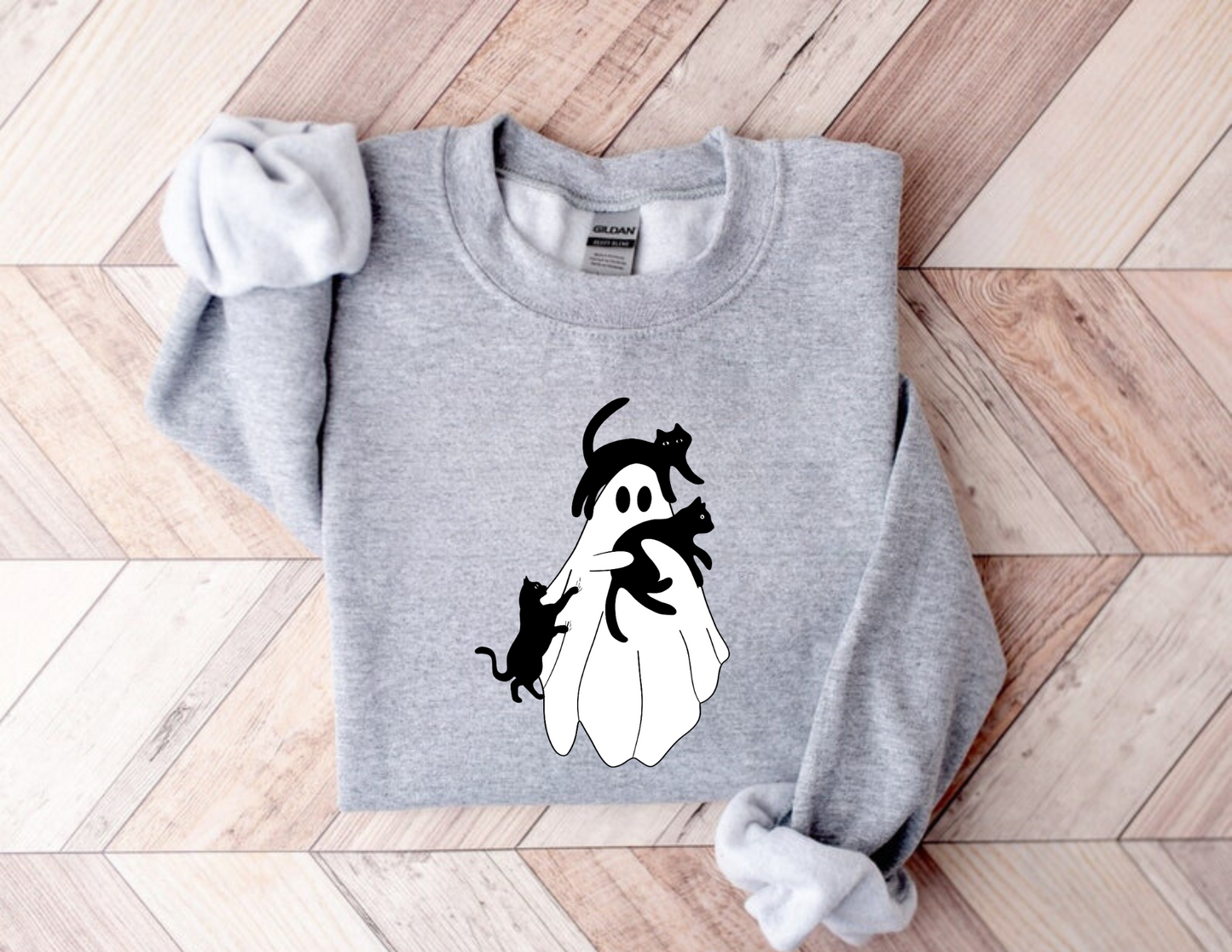 A stylish oversized sweatshirt with a cute and spooky ghost cat design, perfect for Halloween and cat lovers. The black cat ghost adds a touch of whimsy to your fall outfit.