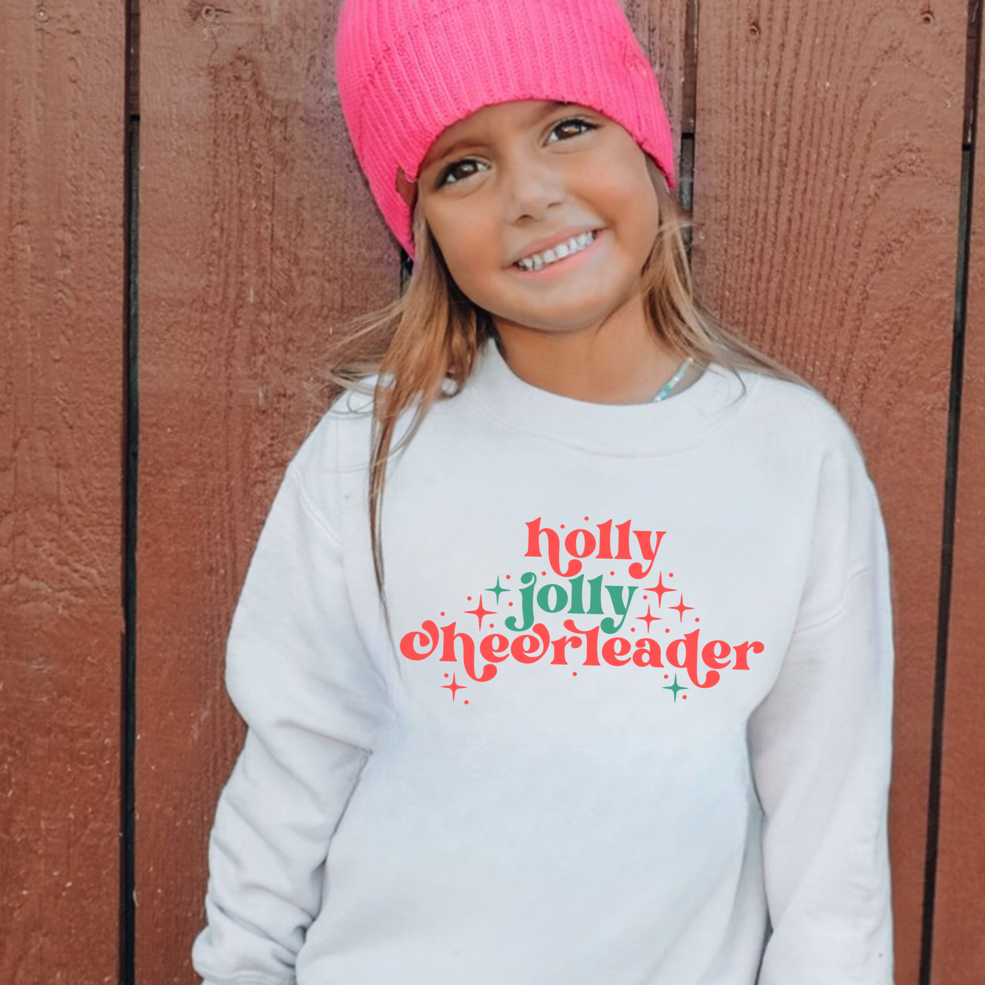 Holly Jolly Cheerleader Christmas sweatshirt on Gildan 18000 crewneck — festive holiday cheer design for girls.