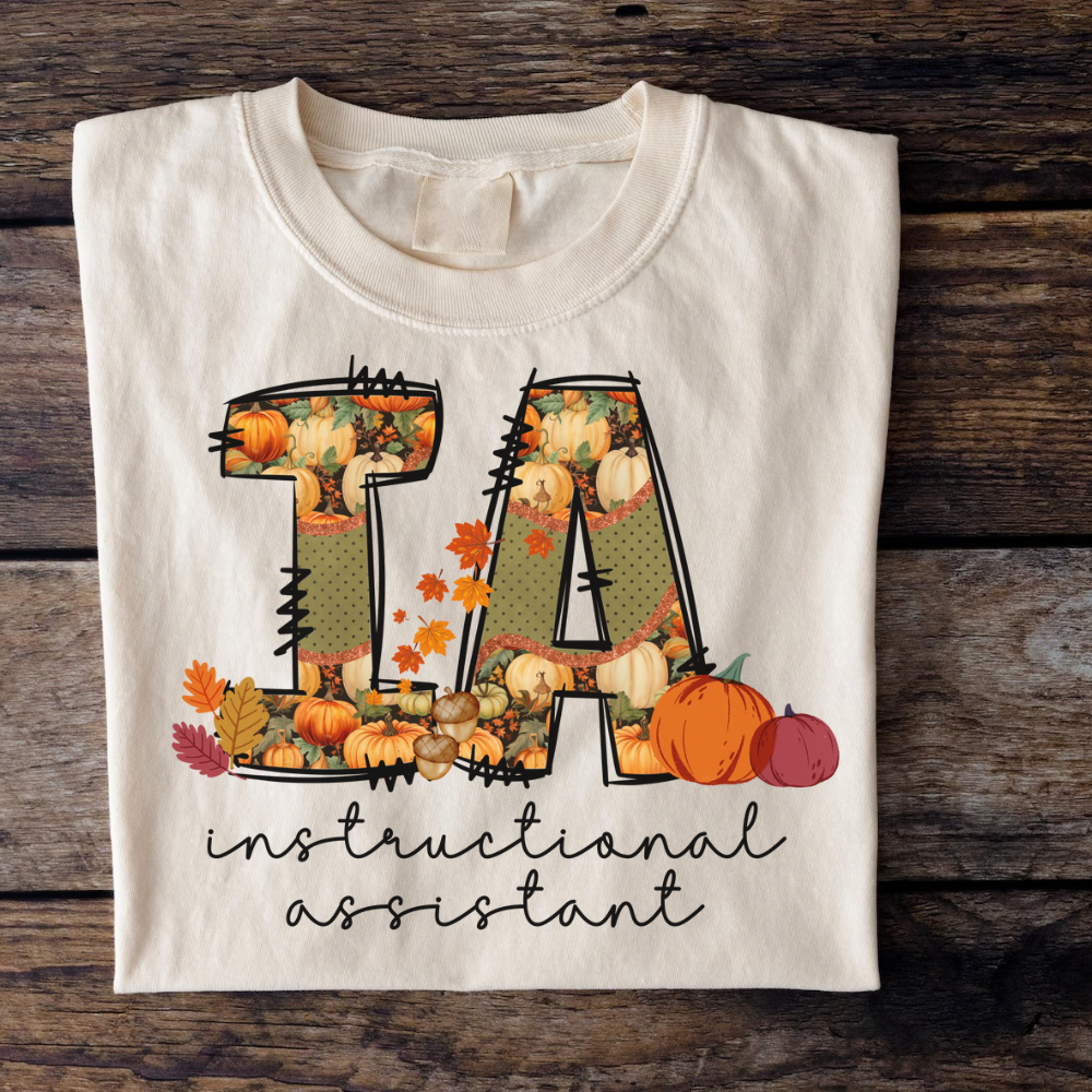Comfort Colors instructional assistant fall sweatshirt in cozy autumn tones, flat lay teacher assistant crewneck shirt for women