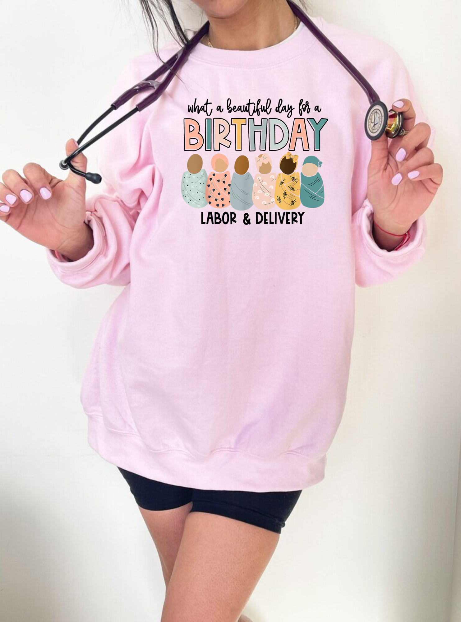 A Labor and Delivery Nurse Crewneck Sweatshirt with the text "It's a beautiful day for a birthday". This nurse sweater is designed for RNs and registered nurses working in labor and delivery (L&D). Showcase your style and dedication as an L&D nurse with this cute and comfortable nurse sweatshirt. Shop now and add this unique OB Nurse sweatshirt to your nurse clothes collection.
