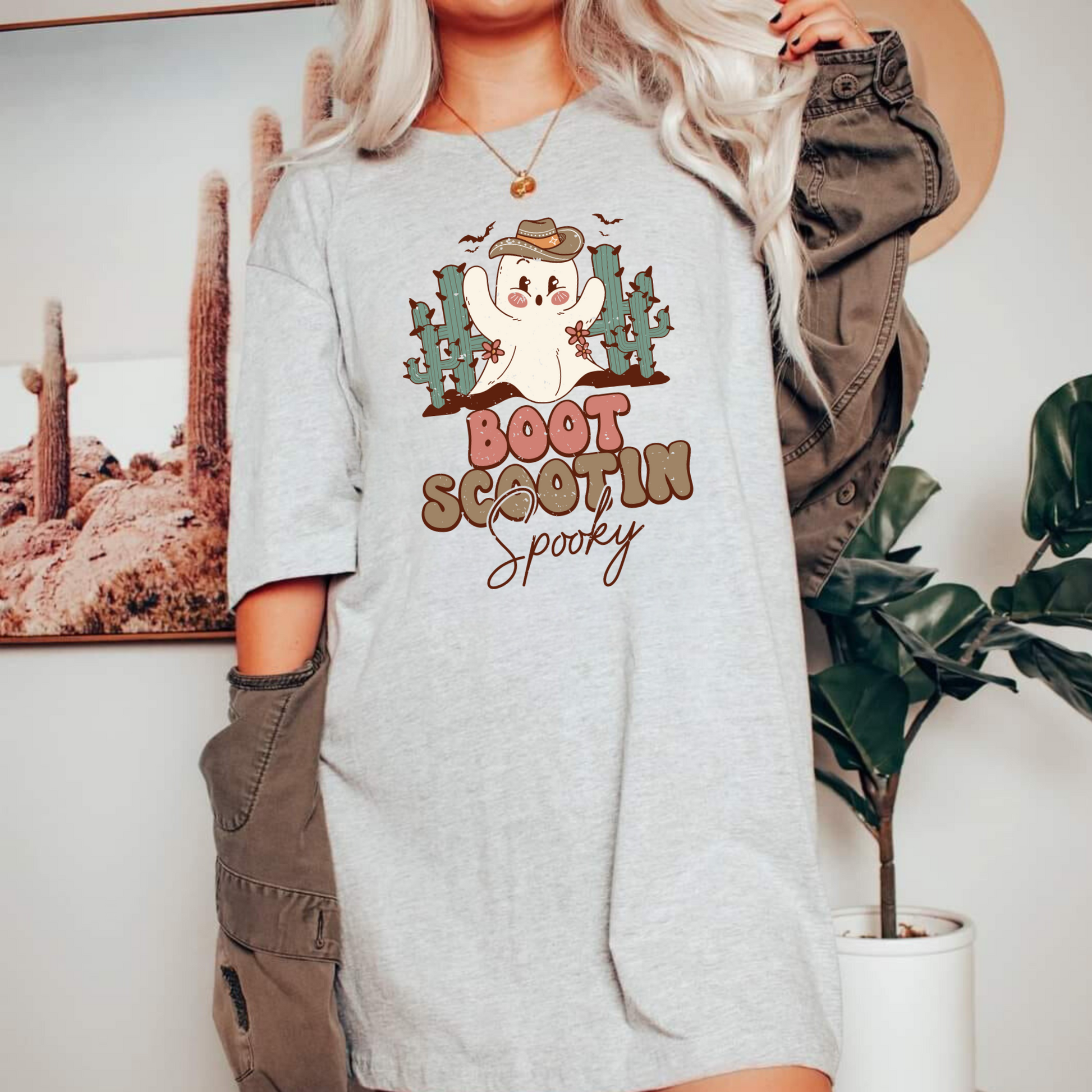 Trendy oversized preppy Western Halloween shirt with "Boot Scootin' Spooky" cowboy design - Embrace the spirit of Western Halloween and autumn with this stylish and playful shirt featuring a ghost cowboy. Perfect blend of retro and trendy fashion for your fall festivities.