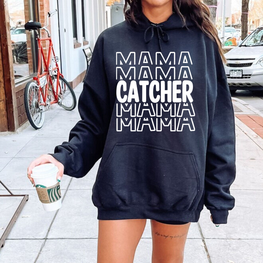 A comfortable and stylish baseball mom hoodie sweatshirt with the words 'Catcher Mama'. This baseball mom outfit is perfect for game day at the baseball game, featuring a cozy design that celebrates the role of a dedicated catcher mom.