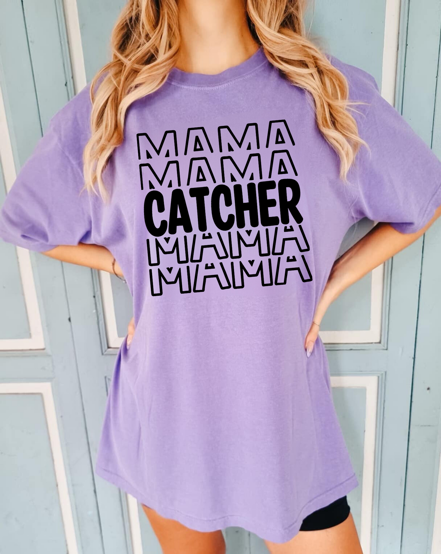 A stylish baseball mom shirt with the text 'Catcher Mama', perfect for game day and showing off your love for baseball. The shirt features a comfortable fit and is a great choice for a mom outfit at the baseball game.