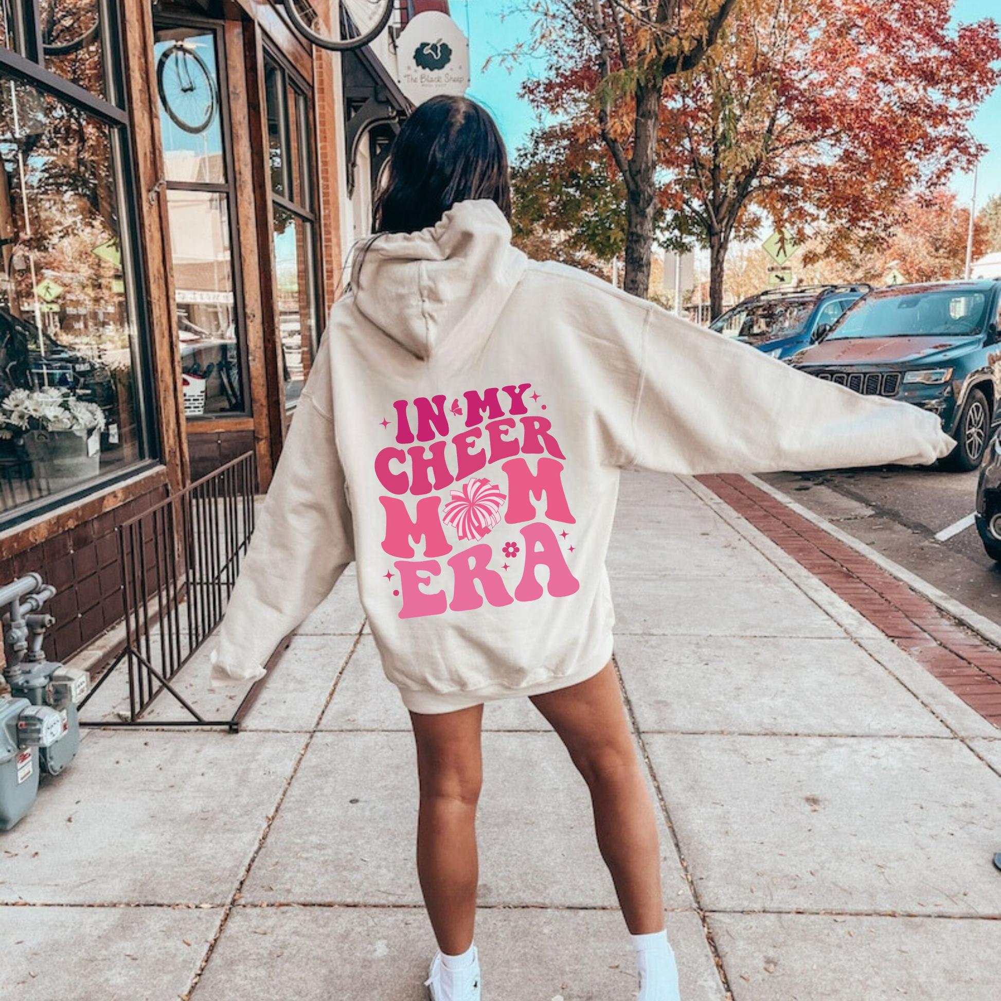 A comfortable hoodie for cheer moms with the text 'In My Cheer Mom Era'. This sweatshirt is ideal for showcasing support for cheerleaders, offering a mix of comfort and style in a humorous design.