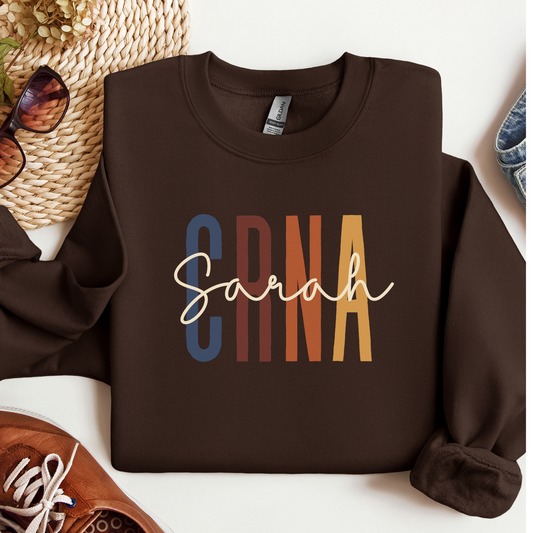 Custom CRNA sweatshirt with personalized name printed on a cozy crewneck, designed for certified registered nurse anesthetists, hospital wear, off-duty comfort, and a thoughtful medical professional gift