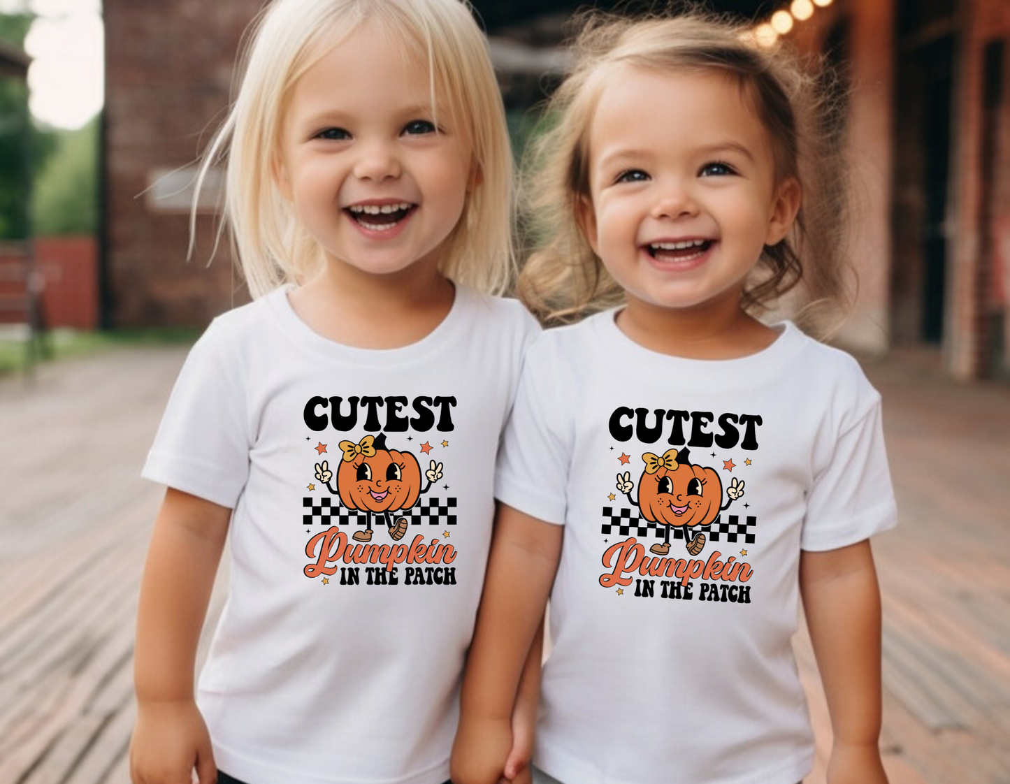 An adorable Halloween shirt for girls with the phrase 'Cutest Pumpkin In The Patch', featuring a preppy and playful design. The shirt adds a unique touch to her Halloween outfit, embodying the essence of cute Halloween fun.