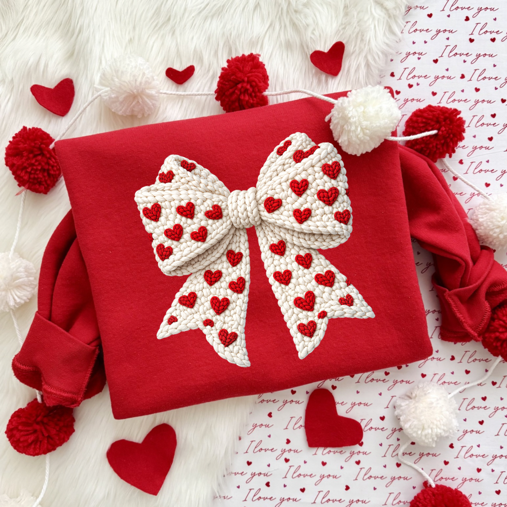 Woman wearing a faux crochet bow Valentine’s Day crewneck sweatshirt styled for a cozy winter outfit