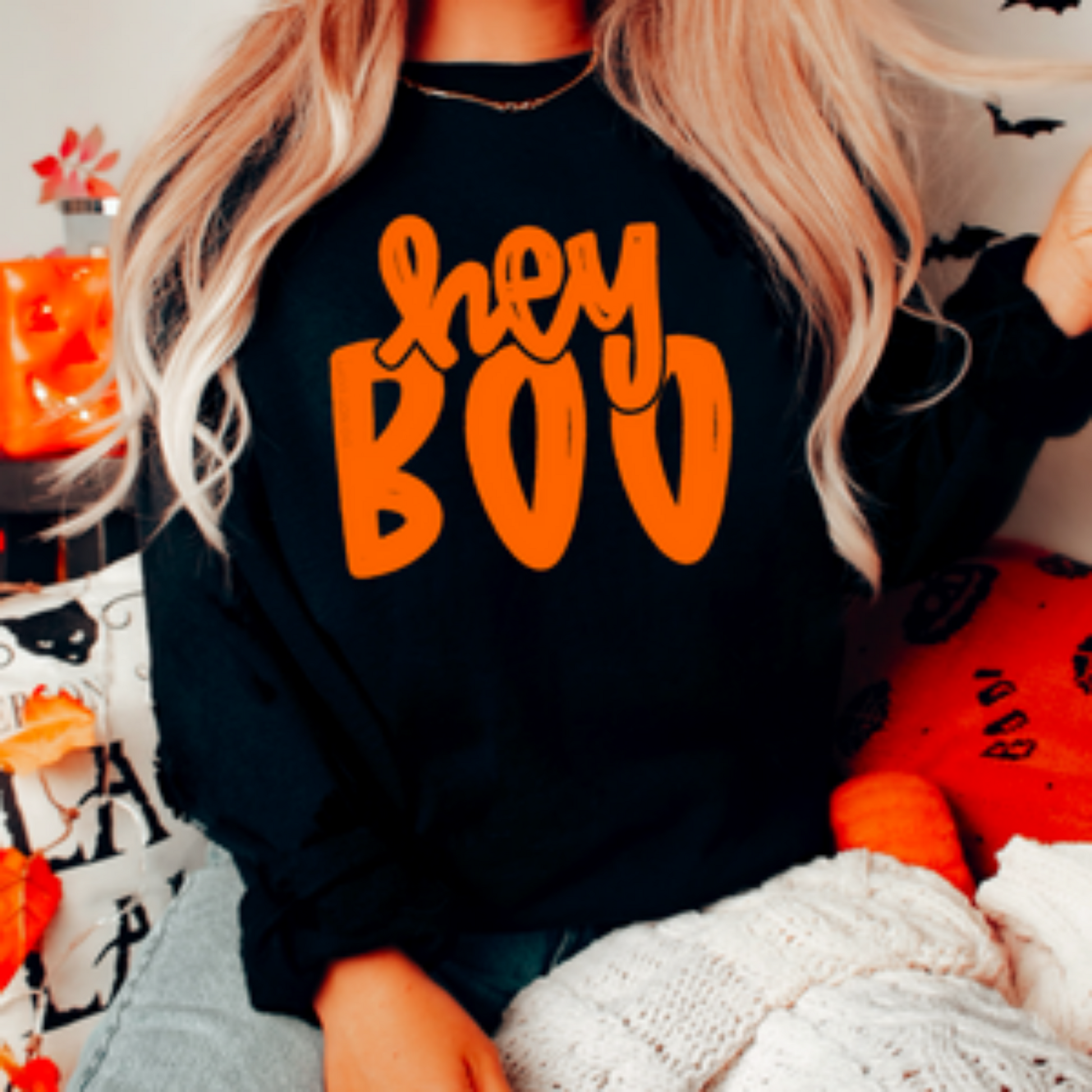 Halloween-themed sweatshirt with the phrase 'Hey Boo' in spooky font.