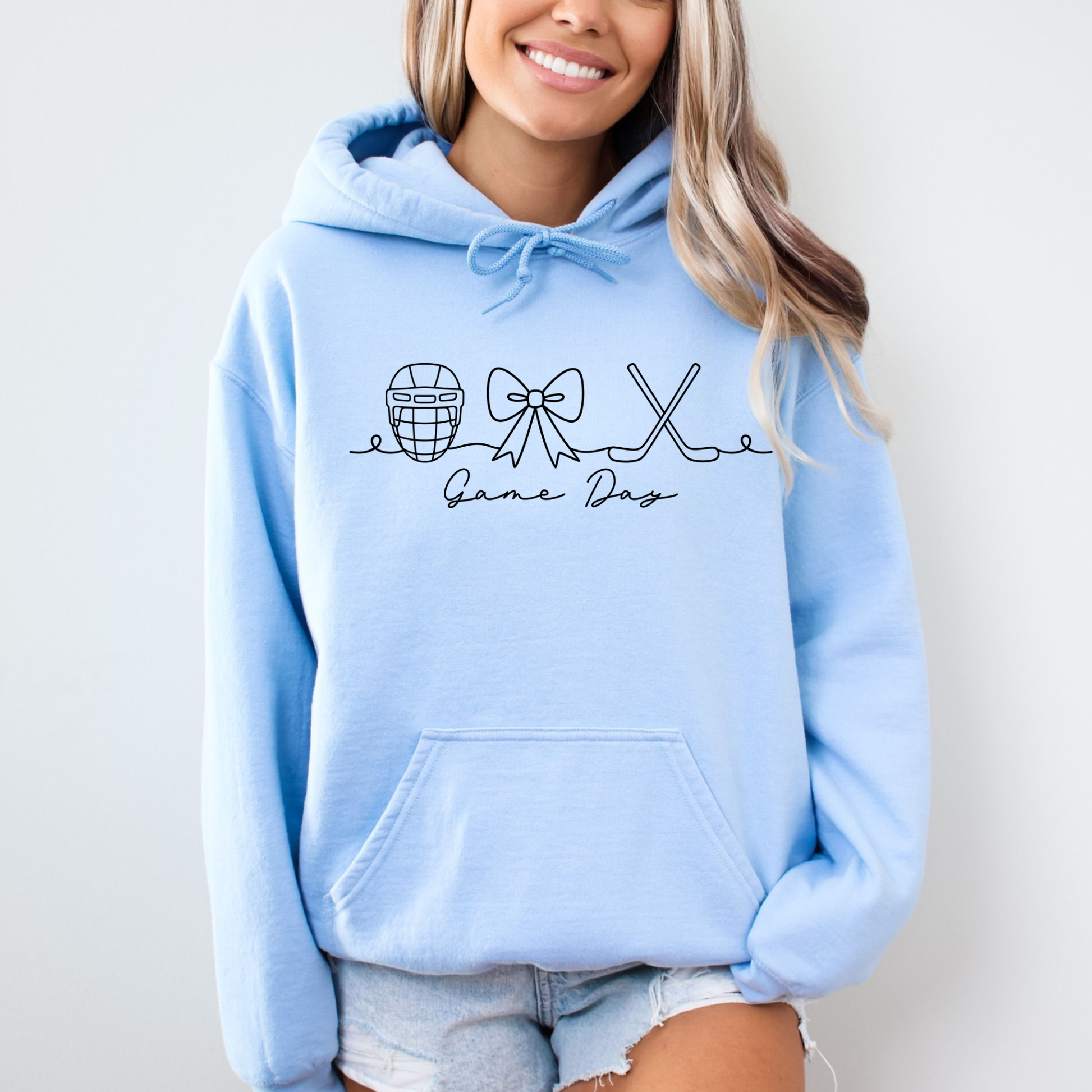Cozy women’s hockey game day hoodie featuring a sporty bow graphic, perfect for hockey moms, cold rink days, tournaments, and casual team spirit outfits.