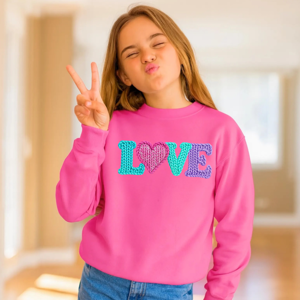 Girl wearing a LOVE Valentine’s Day sweatshirt styled for a cozy winter outfit