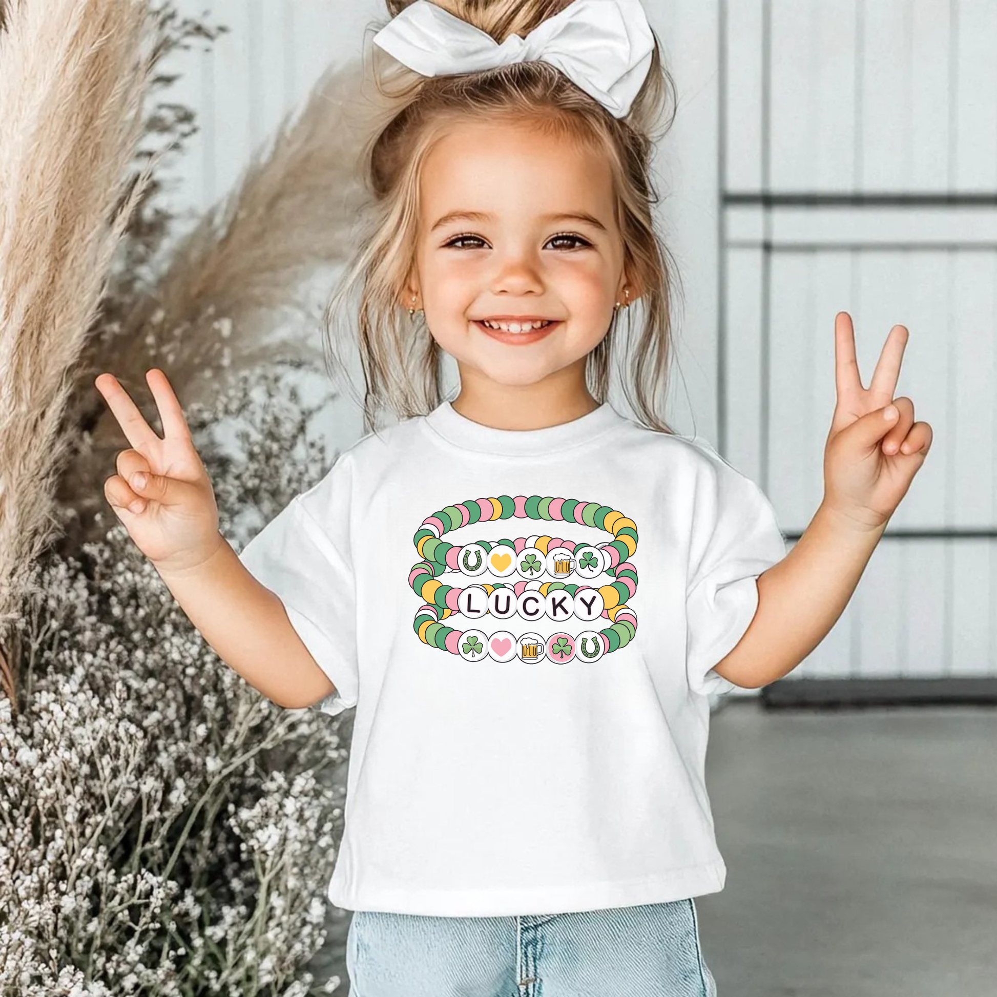 lucky st patricks day shirt for girls friendship bracelet design, cute girls st patricks day school shirt, festive kids lucky shirt for spring, girls holiday shirt with bracelet graphic, st patricks day outfit for girls