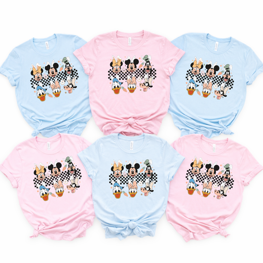matching family Easter shirts in pastel blue and pink laid flat for spring park vacation outfits