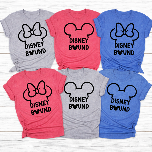 Matching family travel day shirts in heather gray, heather red, and heather royal blue flat lay on white wood background, soft unisex vacation tees for airport outfit and trip reveal