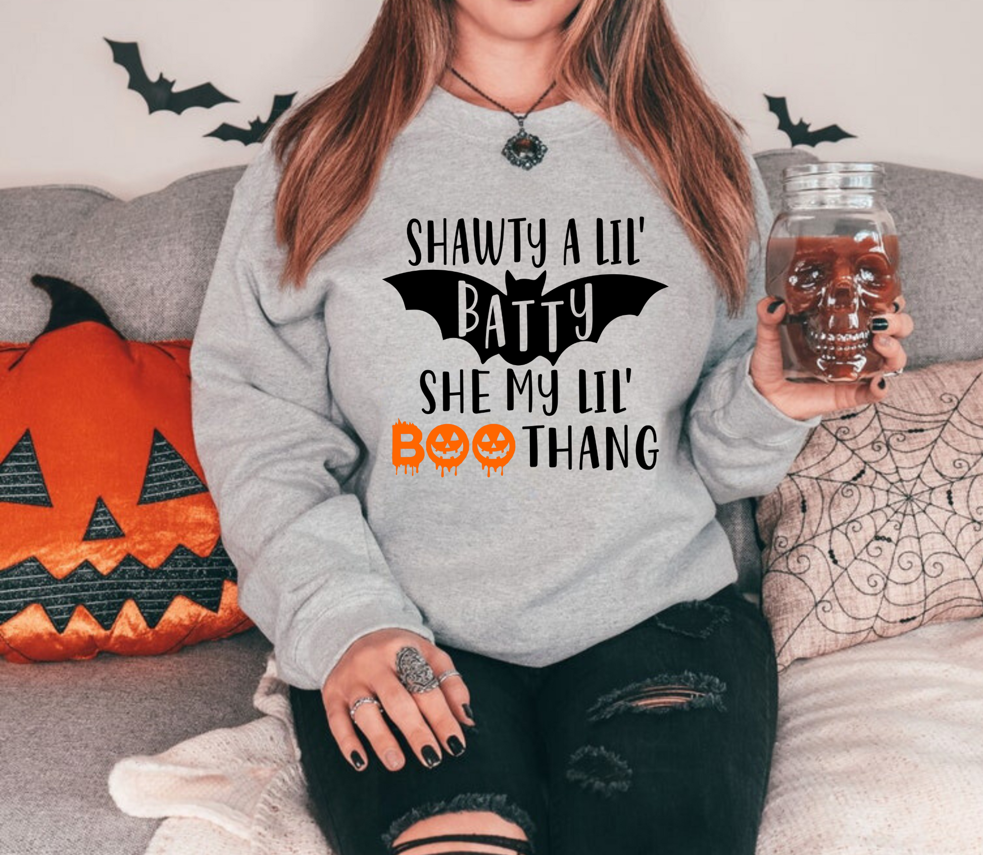Funny Halloween crewneck sweatshirt with "Shawty a lil batty she my lil boo thang" design - Embrace the cozy and humorous side of fall fashion with this crewneck sweatshirt. Perfect for adding some laughter to your autumn outfits during the spooky season.