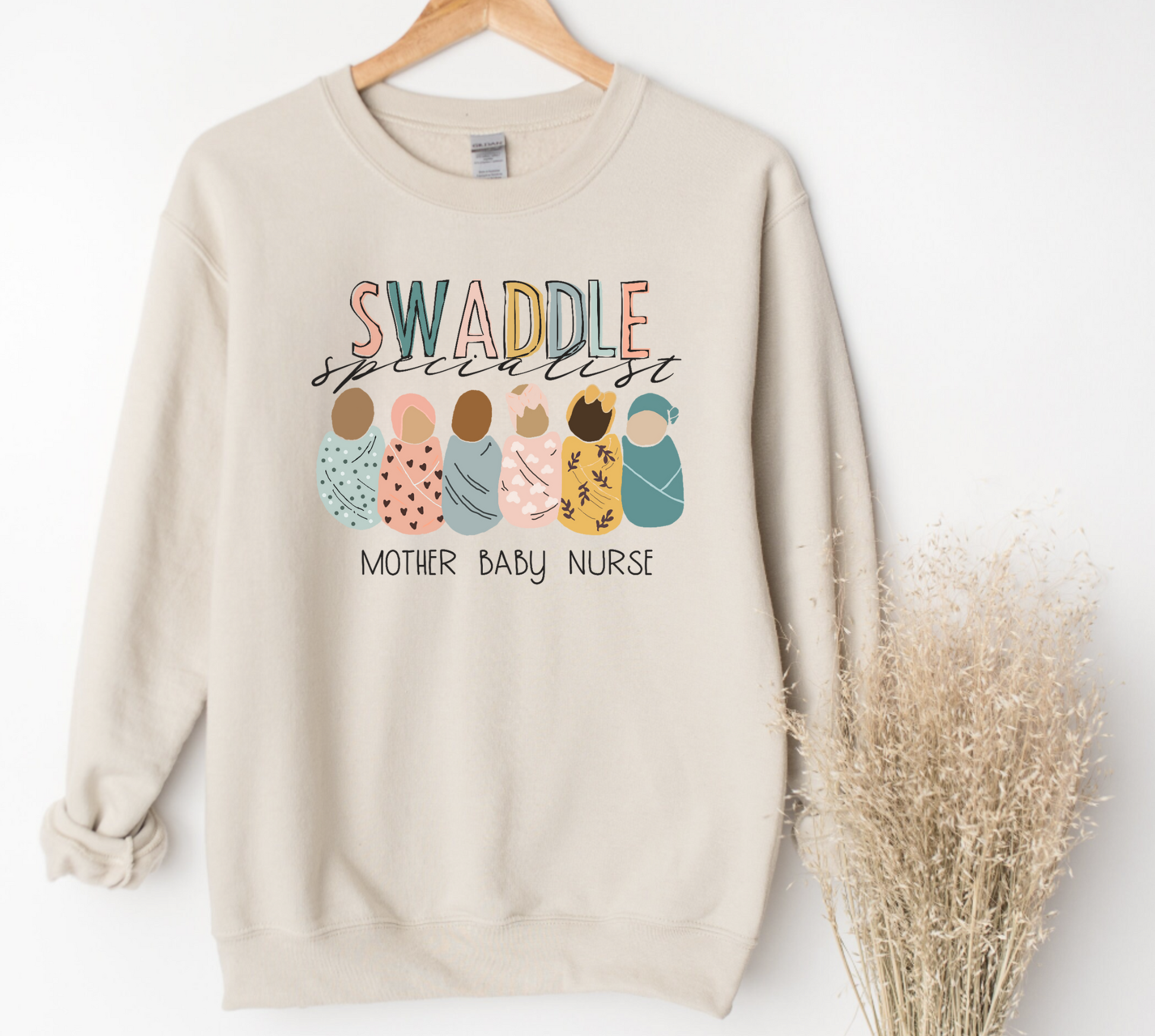 Elevate your nurse work outfit with our stylish Mother Baby Nurse Crewneck Sweatshirt. Designed for RNs and registered nurses specializing in postpartum care, this cute nurse sweater is a must-have. Stay cozy and comfortable while showcasing your dedication as an OB nurse. Shop now for the perfect nurse sweatshirt to complete your postpartum RN wardrobe and make a fashionable statement in your nurse clothes.