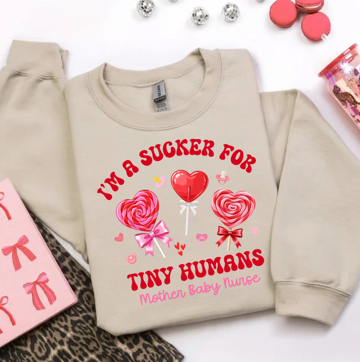 Valentine’s Day nurse sweatshirt for women that says I’m a sucker for tiny humans, perfect for mother baby nurses and NICU nurses