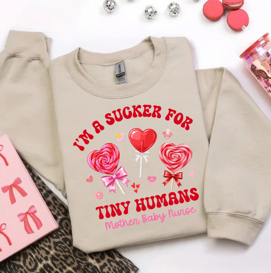 Valentine’s Day nurse sweatshirt for women that says I’m a sucker for tiny humans, perfect for mother baby nurses and NICU nurses