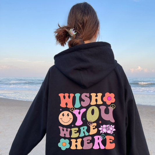 Woman wearing an oversized Pinterest aesthetic hoodie that says wish you were here styled for a cozy neutral outfit